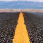 Focus Mode On: Starting the New Year Without Burning Out Close-up of a yellow center line on an empty road fading into the distance